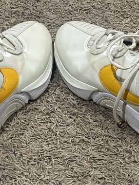 Men NikeCourt Air Zoom GP Turbo in the "Summit White/University Gold" colorway.